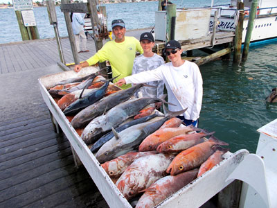 Family with a large haul of fish from a fishing trip in St Pete's Beach, FL