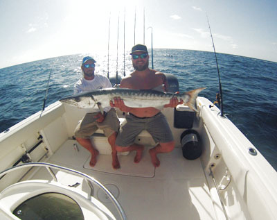 Fishing guest Tony with a barracuda caught on the Offshore Hustler boat